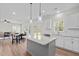Bright kitchen with white cabinets, granite countertops, subway tile backsplash, island, and open concept at 60 Bennett Rd, Coats, NC 27521