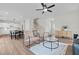 Open-concept living room featuring hardwood floors, a modern ceiling fan, and staircase to upper level at 60 Bennett Rd, Coats, NC 27521