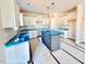 Modern kitchen with white cabinets, island, and granite countertops at 78 Bennett Rd, Coats, NC 27521