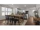 Open dining area next to kitchen, featuring wood floors and modern table set at 918 E Green St # A102, Franklinton, NC 27525