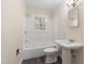 Bathroom features a tiled shower/tub and a pedestal sink at 320 Zollicoffer Ave, Henderson, NC 27536