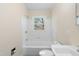This bathroom features a tiled shower/tub and a pedestal sink at 320 Zollicoffer Ave, Henderson, NC 27536