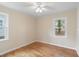Bedroom with neutral walls, hardwood floors, and ample natural light, creating a cozy and inviting space at 320 Zollicoffer Ave, Henderson, NC 27536