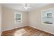 Bright bedroom features hardwood floors, neutral paint, and two windows, creating a serene and comfortable retreat at 320 Zollicoffer Ave, Henderson, NC 27536