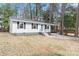 Charming single-story home with a cozy front yard, driveway, and a blue front door at 320 Zollicoffer Ave, Henderson, NC 27536