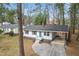 Aerial view of a cozy single-story house with a well-maintained yard, roof, and carport at 320 Zollicoffer Ave, Henderson, NC 27536