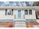 Charming home featuring a blue front door and freshly painted exterior at 320 Zollicoffer Ave, Henderson, NC 27536