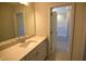 Bright bathroom featuring a large mirror, quartz countertop, and a view of the tub/shower combo at 35 Accord Dr, Youngsville, NC 27596