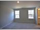 Spacious bedroom with two windows allowing ample natural light and neutral carpet flooring at 35 Accord Dr, Youngsville, NC 27596