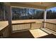 View of the backyard from the covered deck with wood railing at 35 Accord Dr, Youngsville, NC 27596