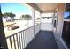 View from the covered porch of the home, showcasing the community landscape and blue skies at 35 Accord Dr, Youngsville, NC 27596