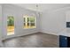 Bright dining area with hardwood floors, a modern chandelier, and a view of the outdoor patio at 35 Accord Dr, Youngsville, NC 27596