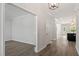 Bright entryway with hardwood floors, modern lighting, and an open floor plan leading to various rooms at 35 Accord Dr, Youngsville, NC 27596