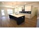 Open-concept kitchen with a spacious island, modern lighting, and access to the adjacent living area at 35 Accord Dr, Youngsville, NC 27596