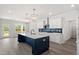 Stylish kitchen with white cabinets, a navy blue island, stainless steel appliances, and herringbone backsplash at 35 Accord Dr, Youngsville, NC 27596