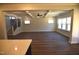 Spacious living room featuring coffered ceilings, large windows, and hardwood floors, perfect for relaxation and gatherings at 35 Accord Dr, Youngsville, NC 27596