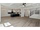 Open-concept living room features coffered ceilings and a modern kitchen with stainless steel appliances at 35 Accord Dr, Youngsville, NC 27596