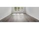 Bright living room featuring lovely gray vinyl floors and a large window allowing ample natural light at 35 Accord Dr, Youngsville, NC 27596