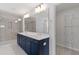 Bathroom featuring double sinks, quartz counters and tiled walk-in shower at 35 Accord Dr, Youngsville, NC 27596