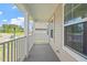 Inviting porch with white columns and railings overlooking a landscaped yard and the neighborhood street at 35 Accord Dr, Youngsville, NC 27596