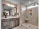 Bathroom featuring dual vanity, a large mirror, and a walk-in shower with a glass door at 55 Accord Dr, Youngsville, NC 27596