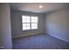 Carpeted bedroom with a large window offering ample natural light at 55 Accord Dr, Youngsville, NC 27596