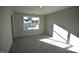 Bright bedroom featuring soft carpet and a large window overlooking the neighborhood at 55 Accord Dr, Youngsville, NC 27596