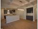 Open concept dining area with modern light fixture, gray cabinets, and hardwood floors at 55 Accord Dr, Youngsville, NC 27596
