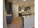 Modern kitchen features gray cabinets, stainless steel appliances, white countertops, and hardwood floors at 55 Accord Dr, Youngsville, NC 27596