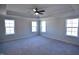 Spacious main bedroom features plush carpeting, a ceiling fan, and a tray ceiling at 55 Accord Dr, Youngsville, NC 27596