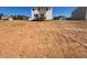 New construction home with spacious backyard surrounded by neighboring houses and a blue sky at 55 Calabria Ct, Franklinton, NC 27525