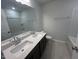 Modern bathroom featuring a double vanity, quartz counters, and a shower-tub combo at 55 Calabria Ct, Franklinton, NC 27525