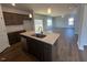 Open-concept kitchen featuring an island, stainless steel sink, and breakfast bar at 55 Calabria Ct, Franklinton, NC 27525