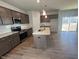 Modern kitchen with granite countertops, an island, and stainless steel appliances at 55 Calabria Ct, Franklinton, NC 27525