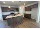 Modern kitchen featuring an island, granite countertops, and stainless steel appliances at 55 Calabria Ct, Franklinton, NC 27525