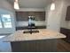 Kitchen featuring granite countertops, modern fixtures, and an island with stainless sink at 55 Calabria Ct, Franklinton, NC 27525