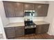 Modern kitchen with granite countertops, stainless steel appliances, and ample cabinet space at 55 Calabria Ct, Franklinton, NC 27525