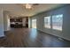 Open-concept living room featuring hardwood floors and natural light from the large windows at 55 Calabria Ct, Franklinton, NC 27525