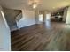 Spacious living room featuring hardwood floors, stairs, and natural light at 55 Calabria Ct, Franklinton, NC 27525