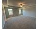 Spacious main bedroom with plush carpet, ceiling fan, and bright windows at 55 Calabria Ct, Franklinton, NC 27525