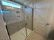 A glass enclosed shower with tiled walls, overhead light, and tiled floor at 55 Calabria Ct, Franklinton, NC 27525