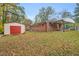 View of the backyard featuring a storage shed and covered patio area at 710 Spring Ln, Sanford, NC 27330