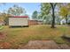 View of the backyard featuring a storage shed and a well maintained lawn at 710 Spring Ln, Sanford, NC 27330