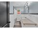 Well-lit bathroom featuring a window, tiled walls, and modern sink at 710 Spring Ln, Sanford, NC 27330