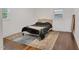 Bright bedroom with two windows, a neutral color scheme, and wood-look floors at 710 Spring Ln, Sanford, NC 27330