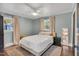 Comfortable bedroom with neutral tones, natural light, and a ceiling fan at 710 Spring Ln, Sanford, NC 27330