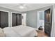 Bedroom featuring calming paint colors, a ceiling fan, and access to the bathroom at 710 Spring Ln, Sanford, NC 27330