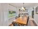Inviting dining room bathed in natural light, complemented by wood table and a glimpse into the modern kitchen at 710 Spring Ln, Sanford, NC 27330