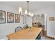 Elegant dining area with a wooden table, stylish lighting, and a seamless transition to the cozy living room at 710 Spring Ln, Sanford, NC 27330