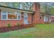 Charming brick home featuring a classic brick chimney and a cozy, inviting entrance at 710 Spring Ln, Sanford, NC 27330